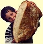 Photo: Boy with large loaf [bigbread.jpg 8kB]